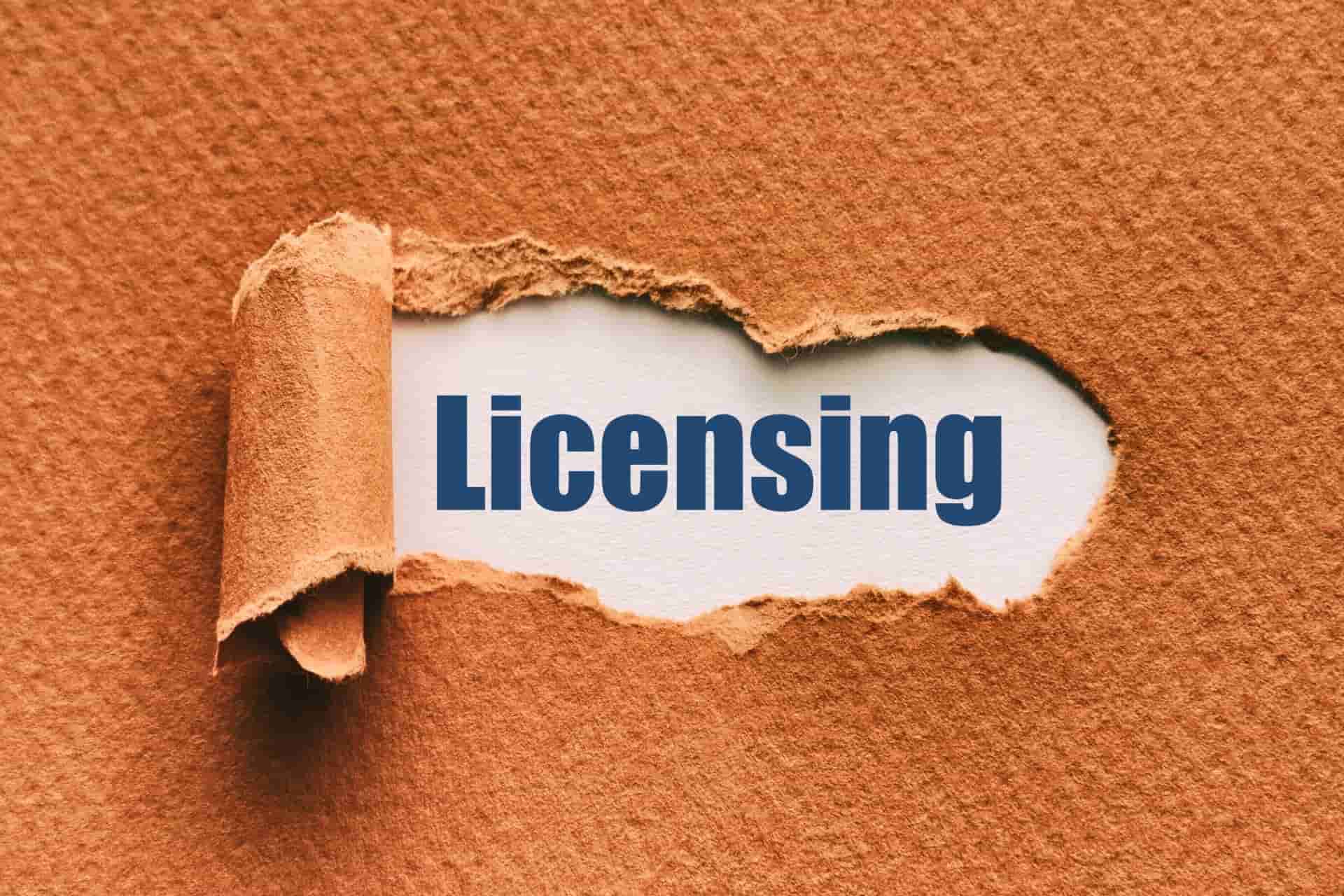 a sheet of paper being torn away revealing the word Licensing